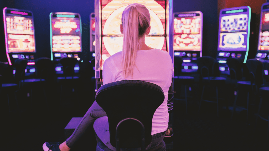 A person playing a slot machine in a casino