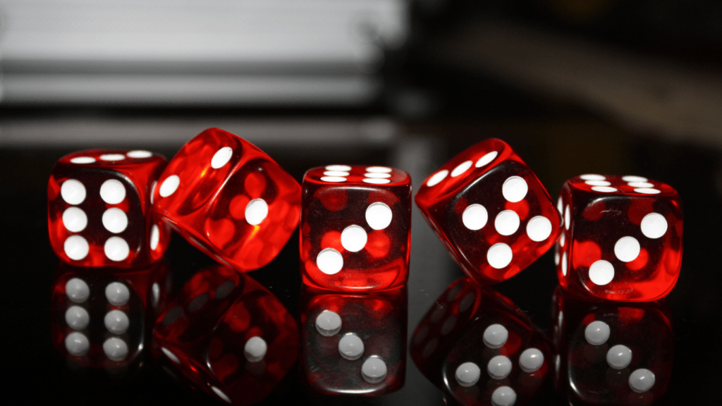 a group of red dice on a black surface