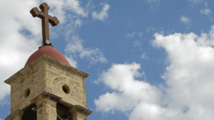 a bell tower with a cross on top of it