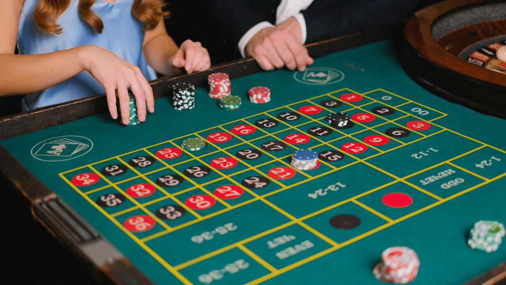 people playing roulette at a casino table