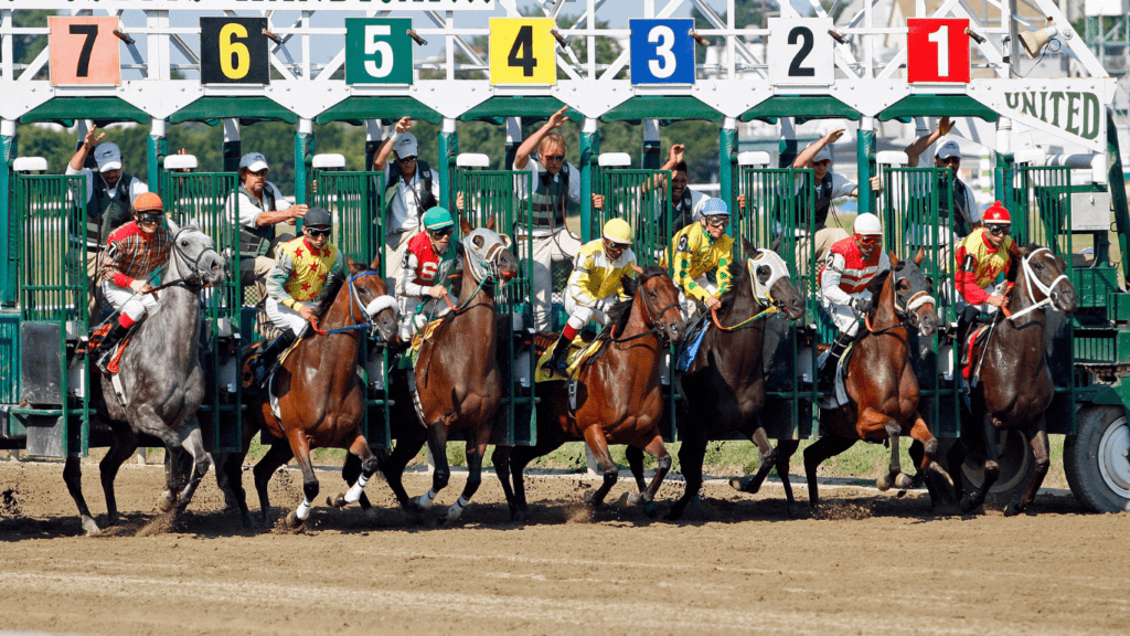 a group of jockeys and horses racing on the track