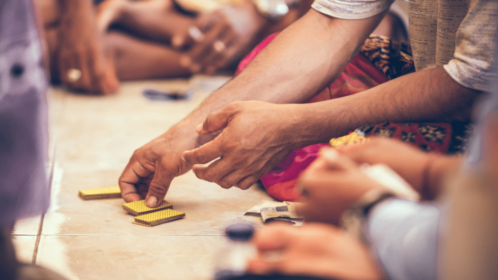 a group of people sitting on the floor playing a board game