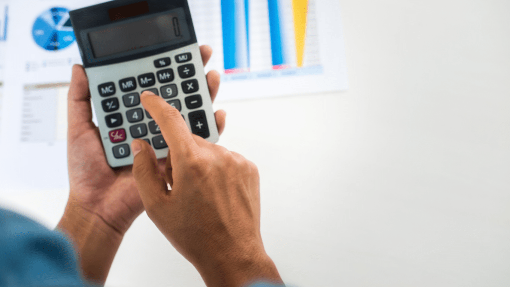 a person using a calculator in front of a wall