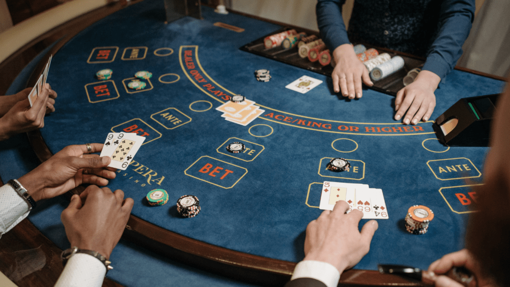 a casino table with several people playing blackjack