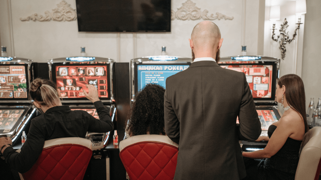 a group of people playing video games in an arcade