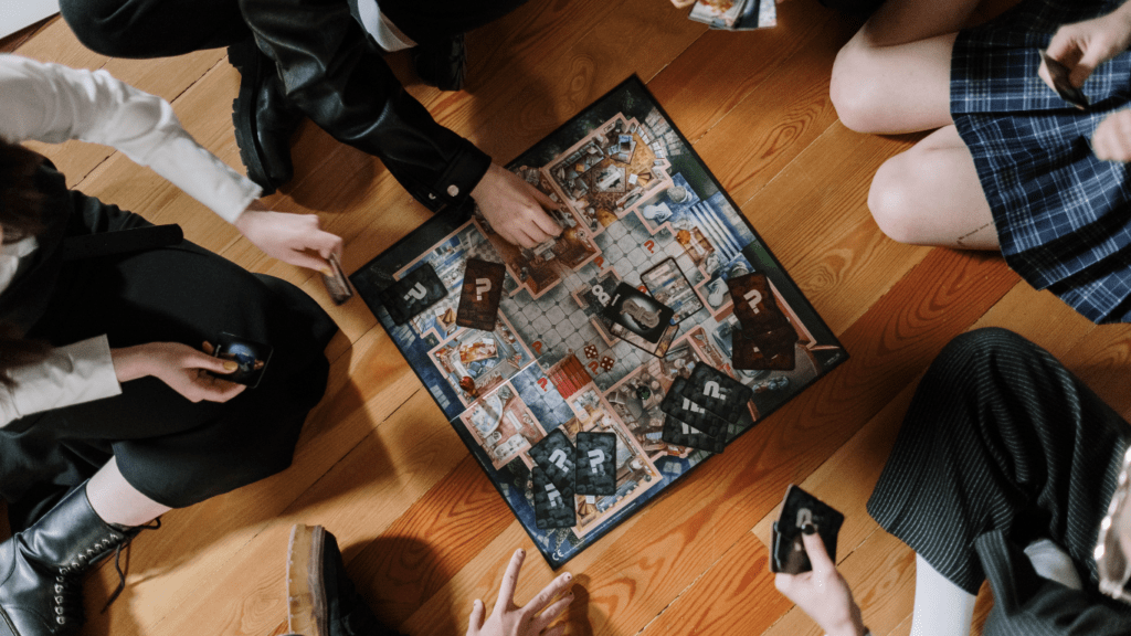 a group of people sitting on the floor playing a board game