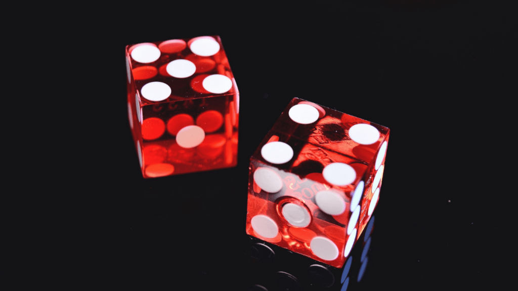 a group of red dice on a black surface