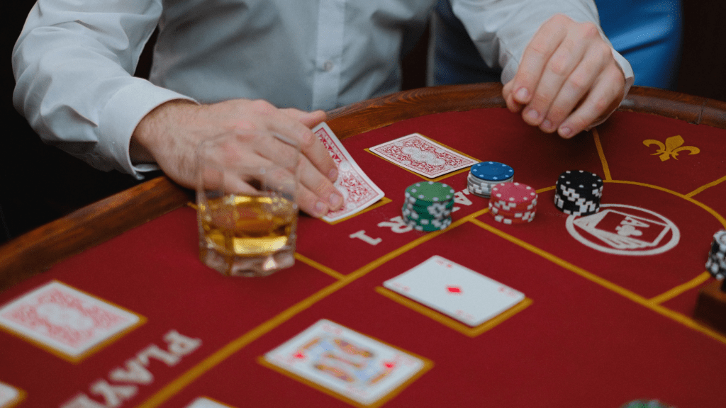 a person in a suit is playing cards on a casino table