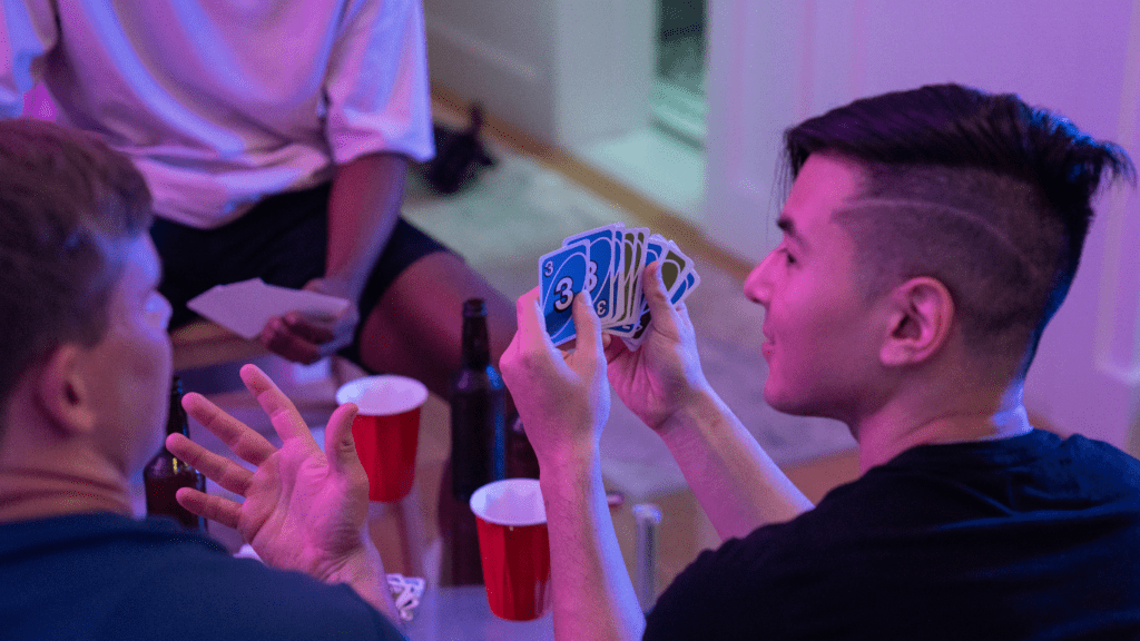 a person is holding a card in their hand while playing poker