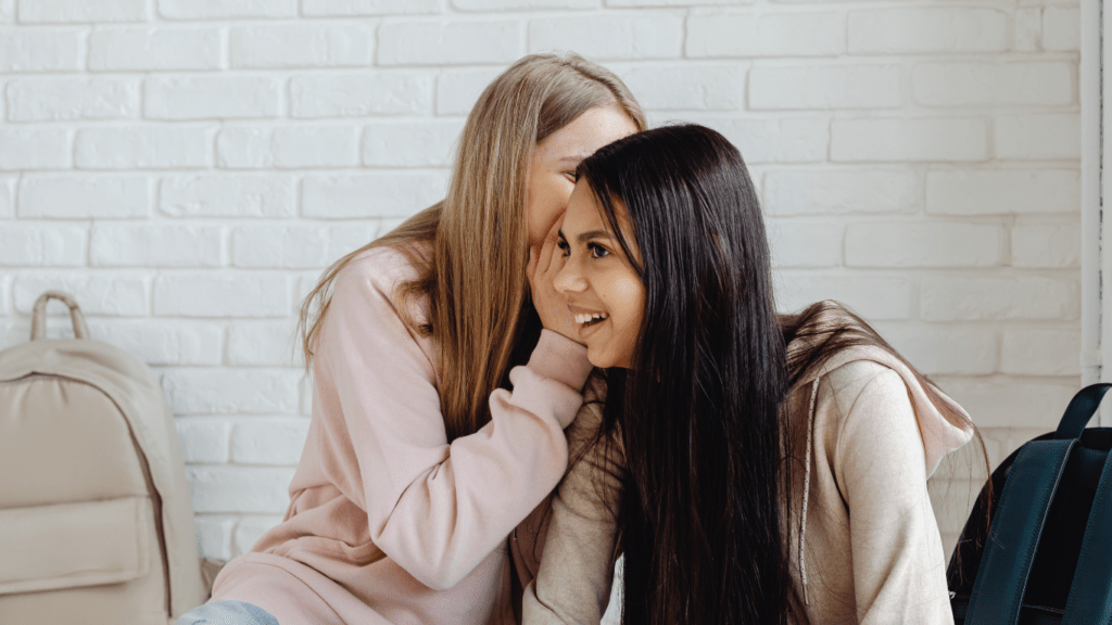 two women are talking and one of them is wearing earrings